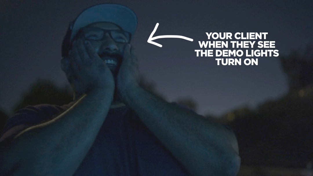 Image of a homeowner seeing their home lit up with a landscape lighting demo kit