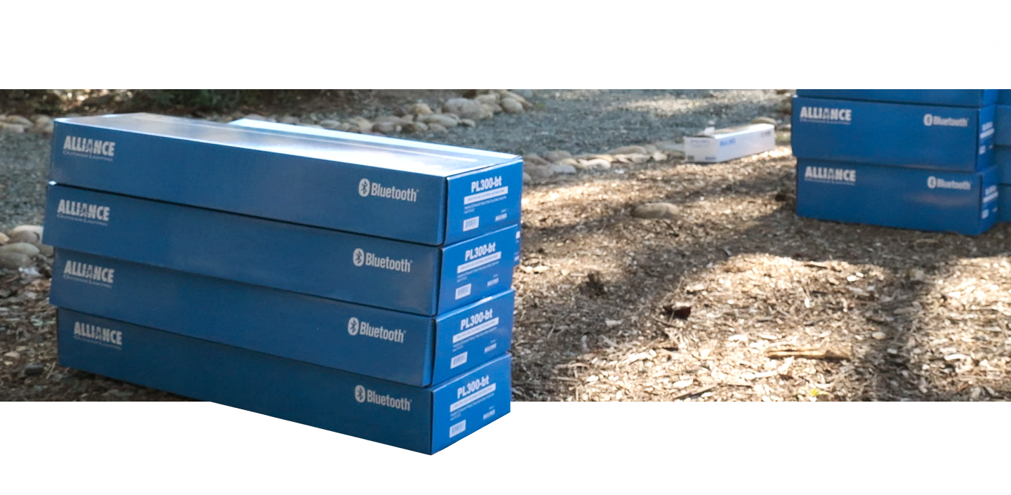 A photo depicting four Alliance PL300-bt boxes stacked and ready to be installed.